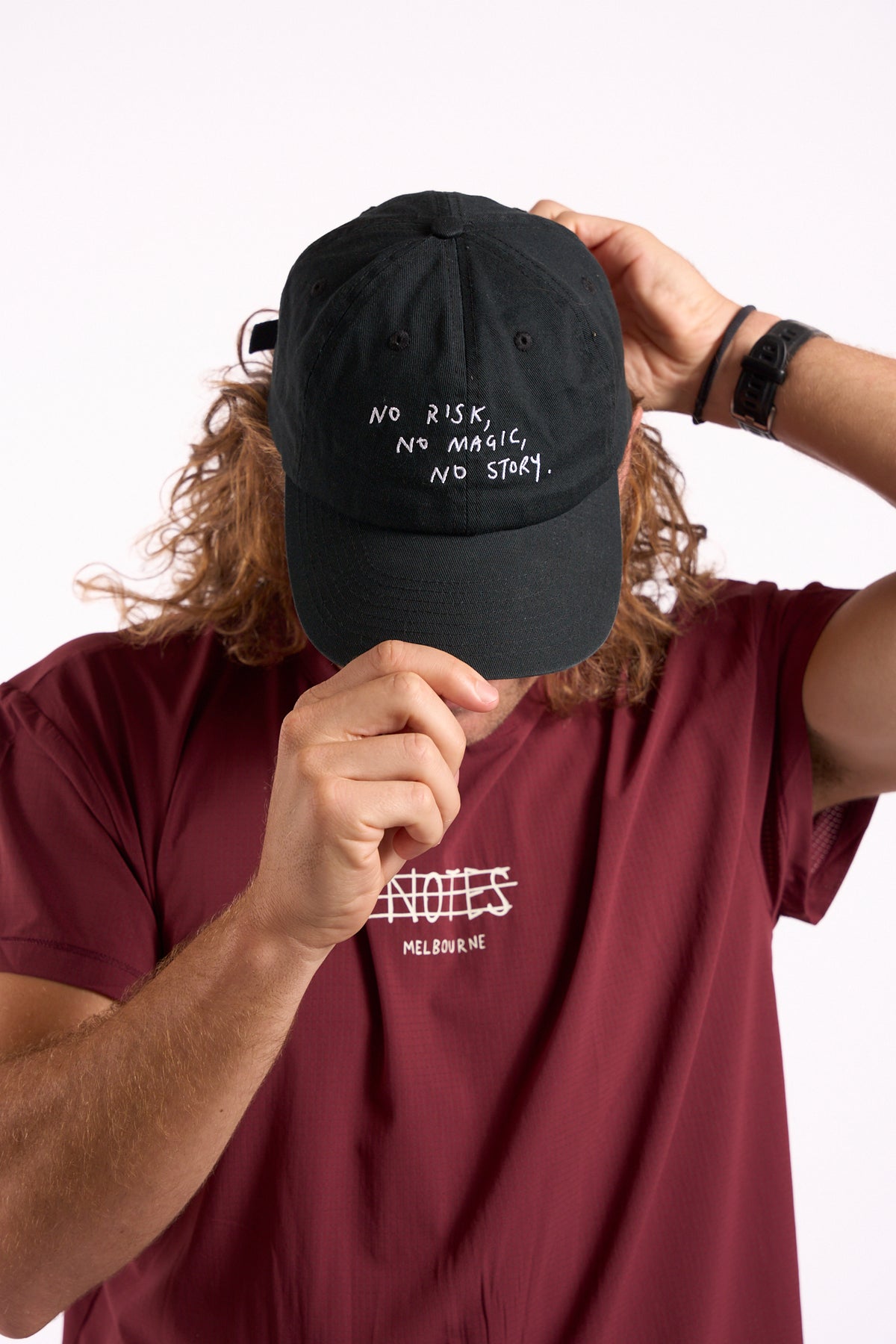 No Risk No Magic No Story cap in washed black, front embroidery, on model