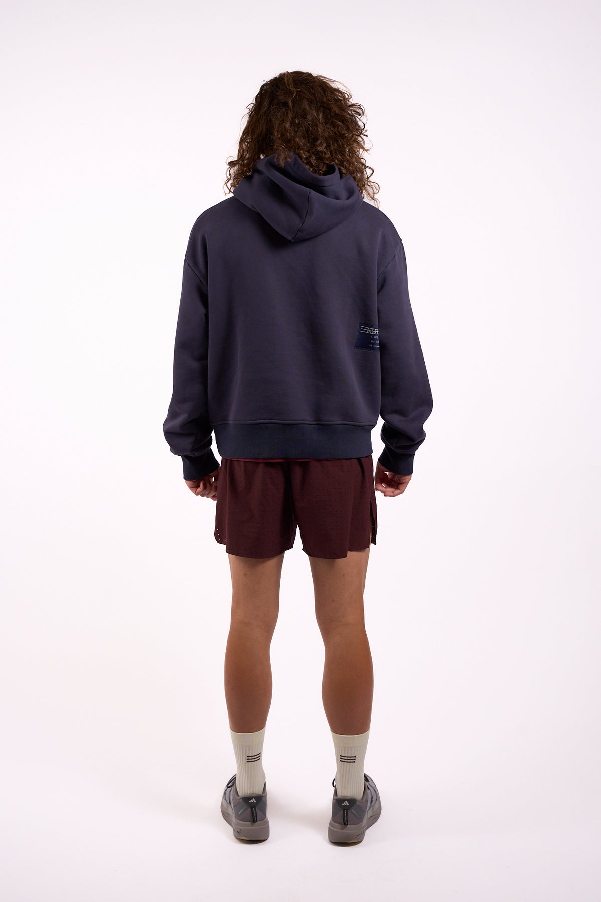 Warm Down Hoodie in Washed Pelagic Blue, full length on model, back view