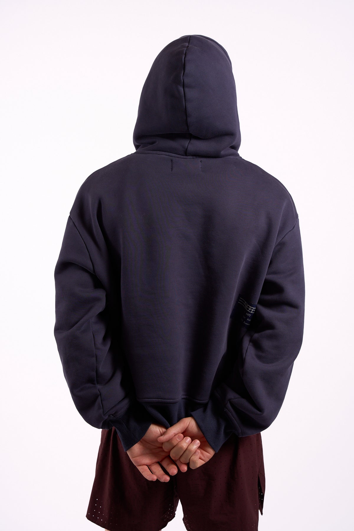 Warm Down Hoodie in Washed Pelagic Blue, back view with hood