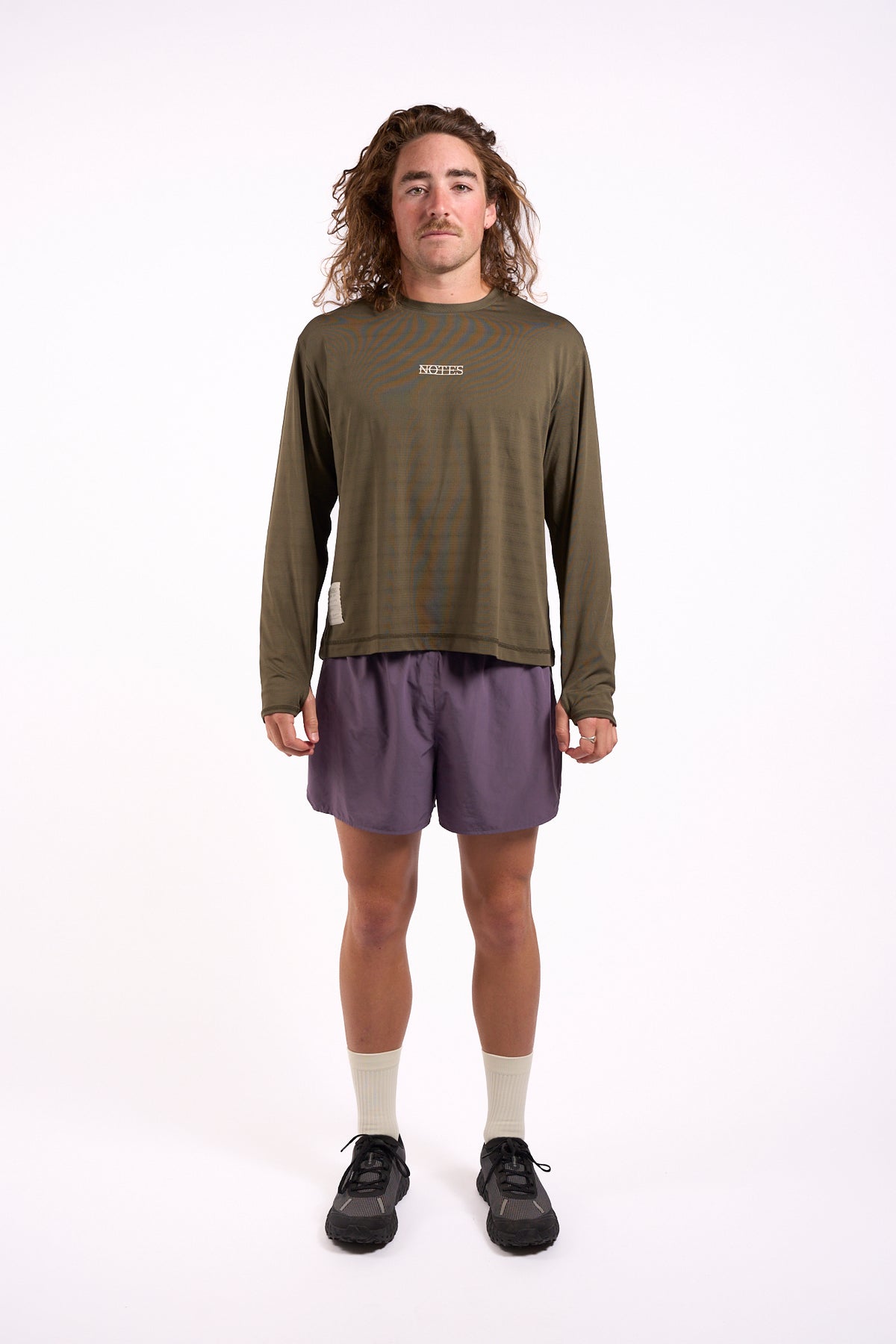 Long Note LS Performance Tee in olive, full length on model, front view