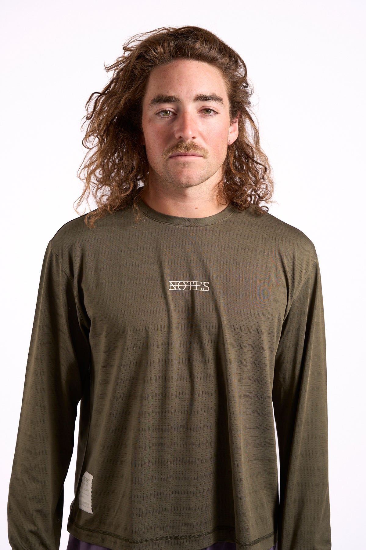 Long Note LS Performance Tee in olive, on model, front view