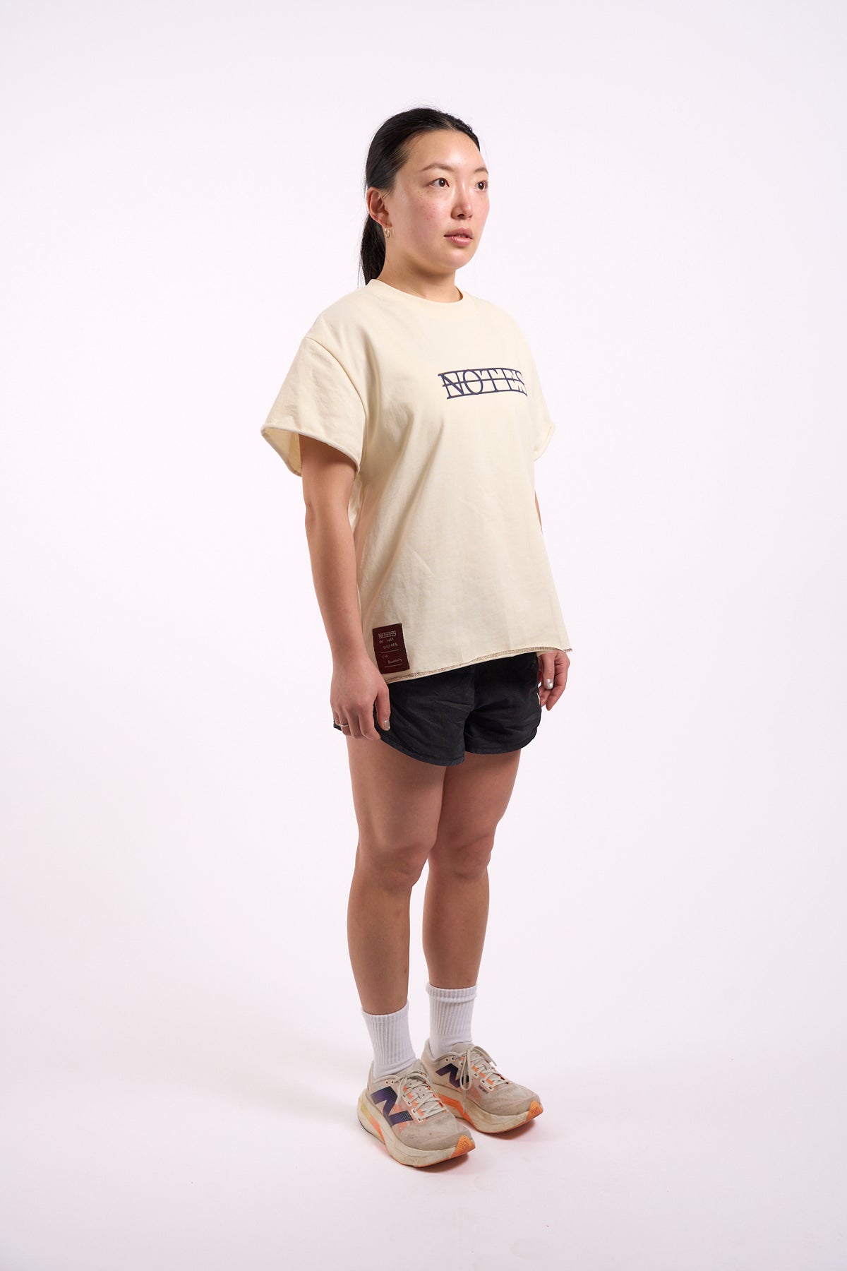 Anniversary Tee in off white, full length on model, side view