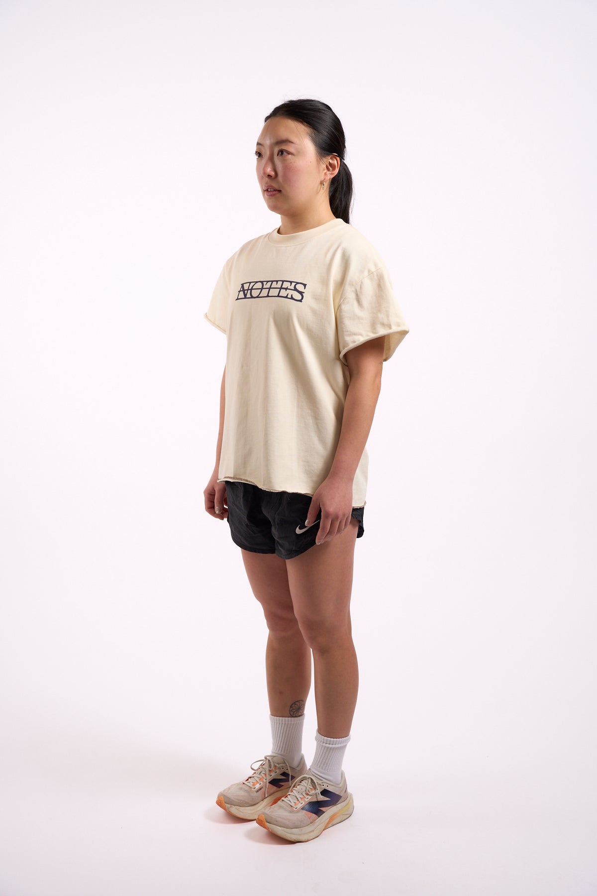 Anniversary Tee in off white, full length on model, side view