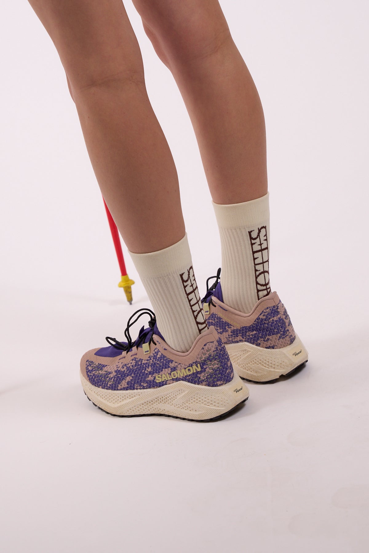 Core Logo Sock in white with brown Notes logo, worn, side view