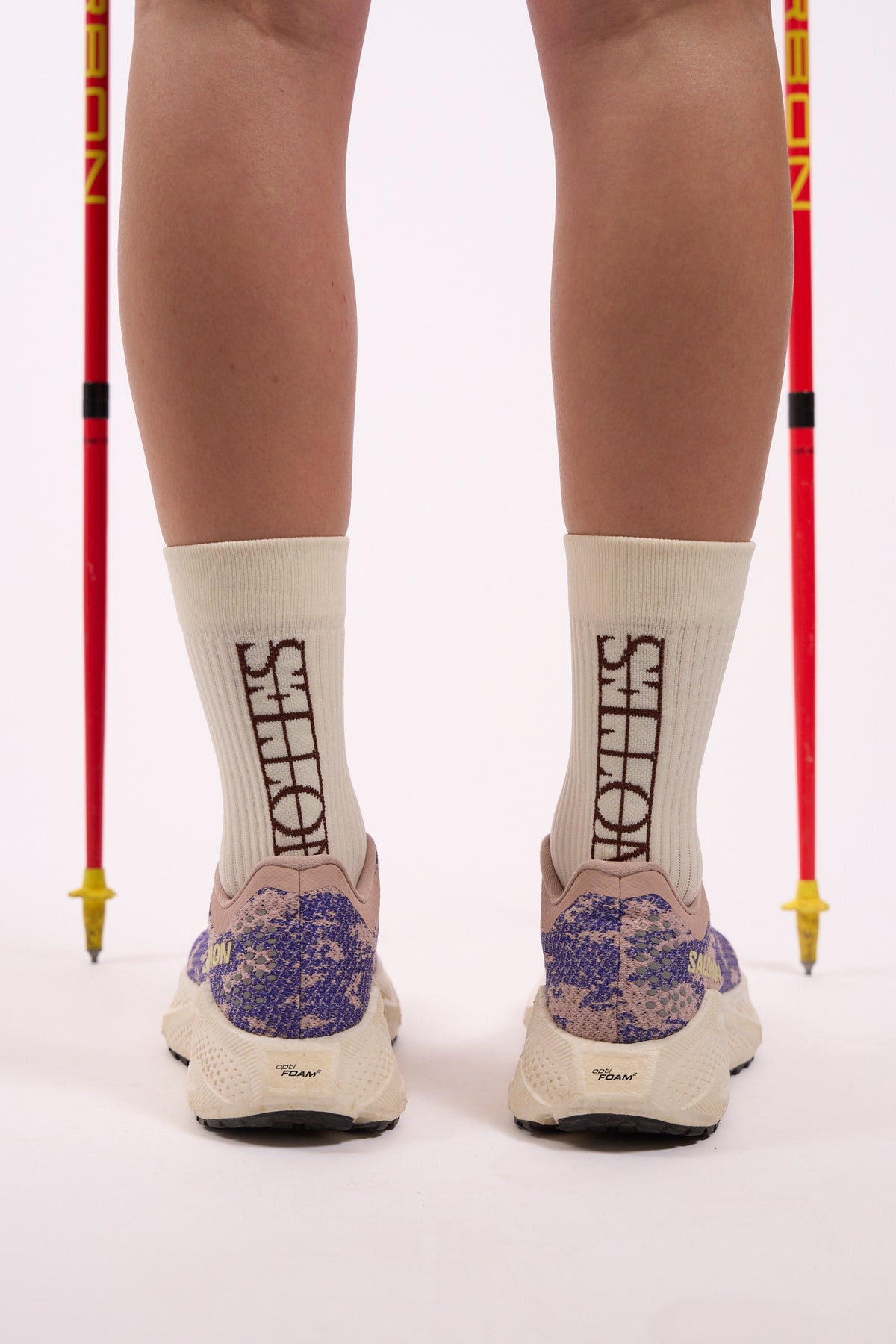 Core Logo Sock in white with brown Notes logo, worn, back view