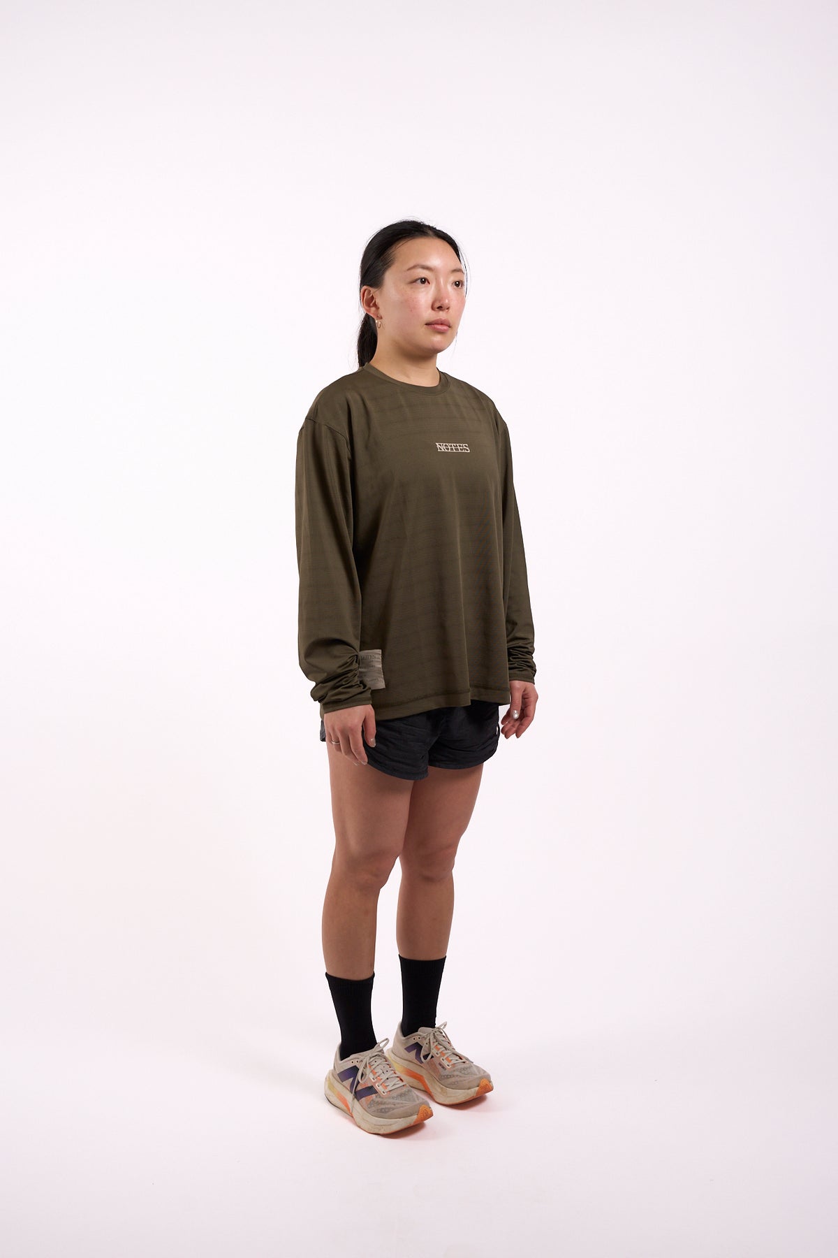 Long Note LS Performance Tee in olive, full length on model, front view