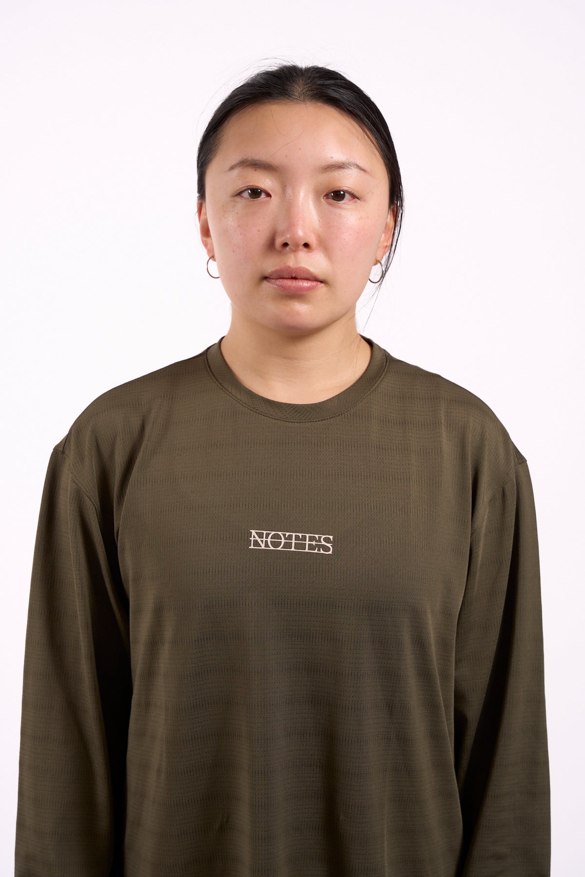 Long Note LS Performance Tee in olive, on model, front view