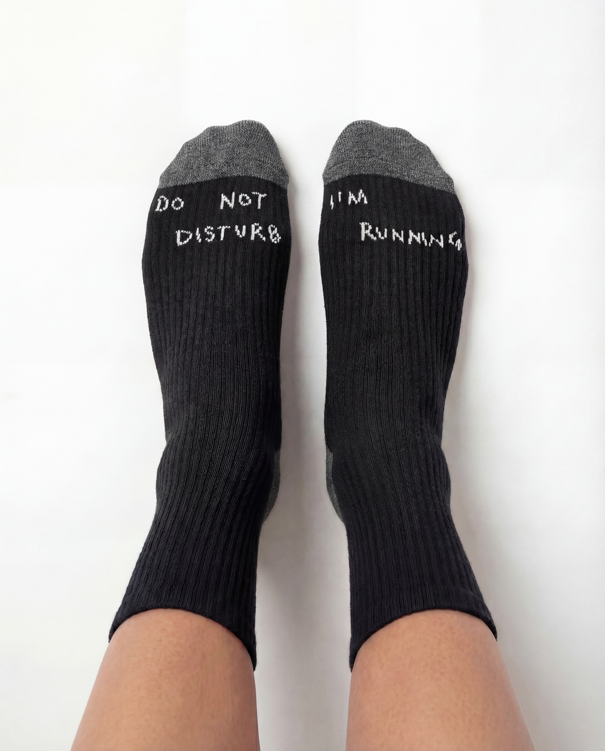 THE DELIVERY SOCKS - BLACK with gray toe caps, featuring "DO NOT DISTURB" and "I'M RUNNING" text.