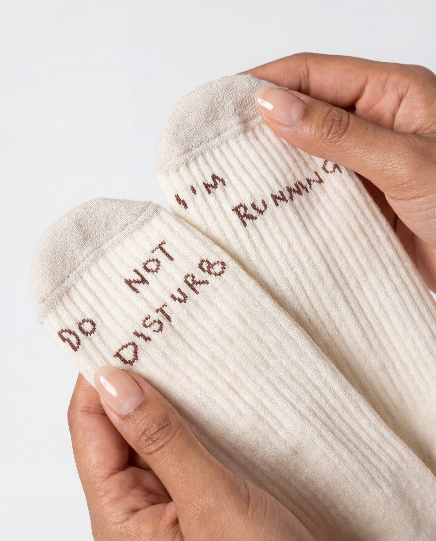 THE DELIVERY SOCKS in off white with "DO NOT DISTURB" and "I'M RUNNING" text on the toes.